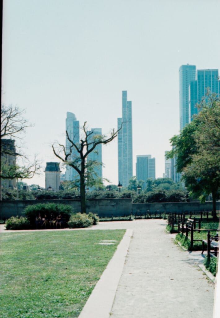 The Chicago skyline appearing through a soft morning haze on the lakefront, shot on analog film.