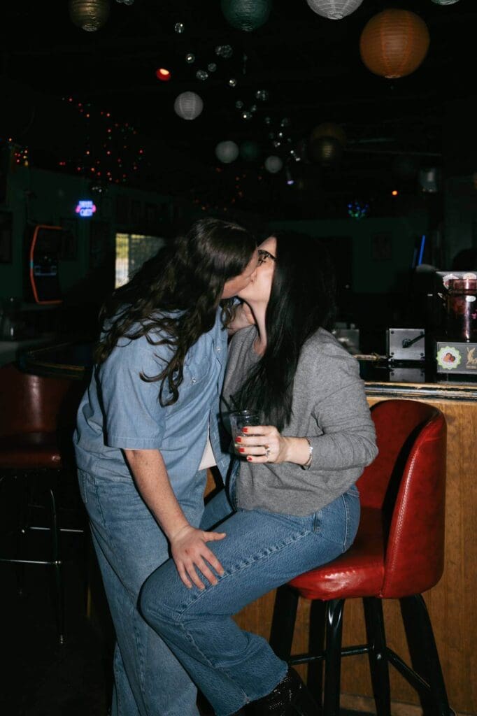 Engagement photos at a gay dive bar in Dallas Fort Worth with neon lighting
