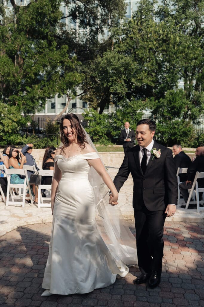 Couple walking through the garden at an Allan House wedding