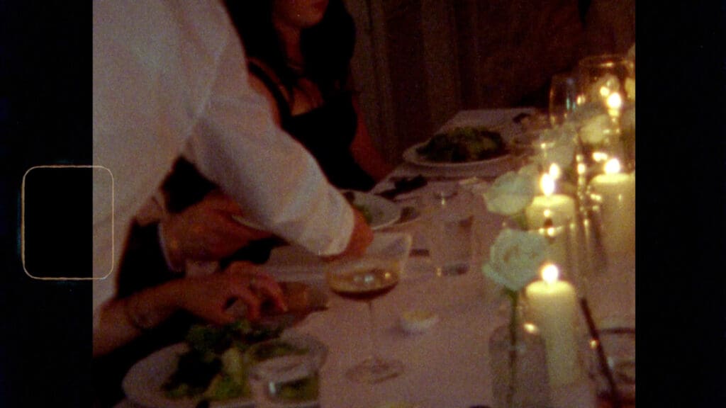 Candid Super 8 wedding film still of a bride and groom walking hand in hand, preserved with vintage texture and natural light.
