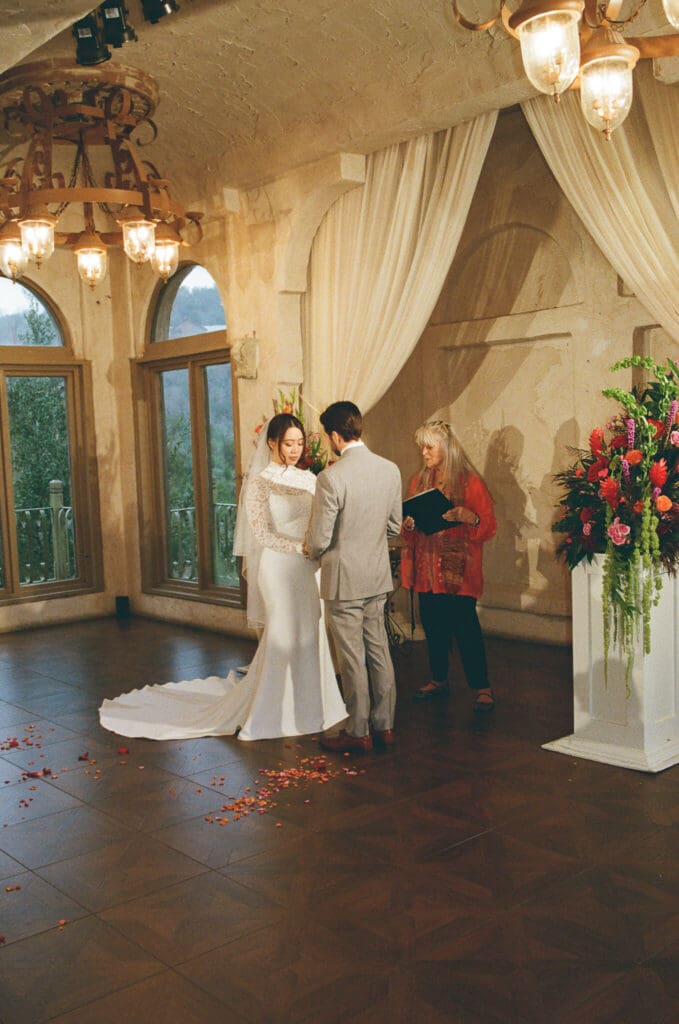 Bride walking through the courtyard at sunset