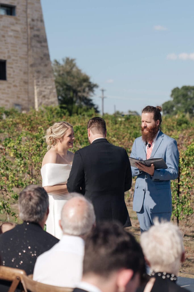 Bride walking down the aisle surrounded by guests
