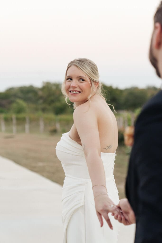 Bridesmaids wearing coordinated dresses and holding bouquets
