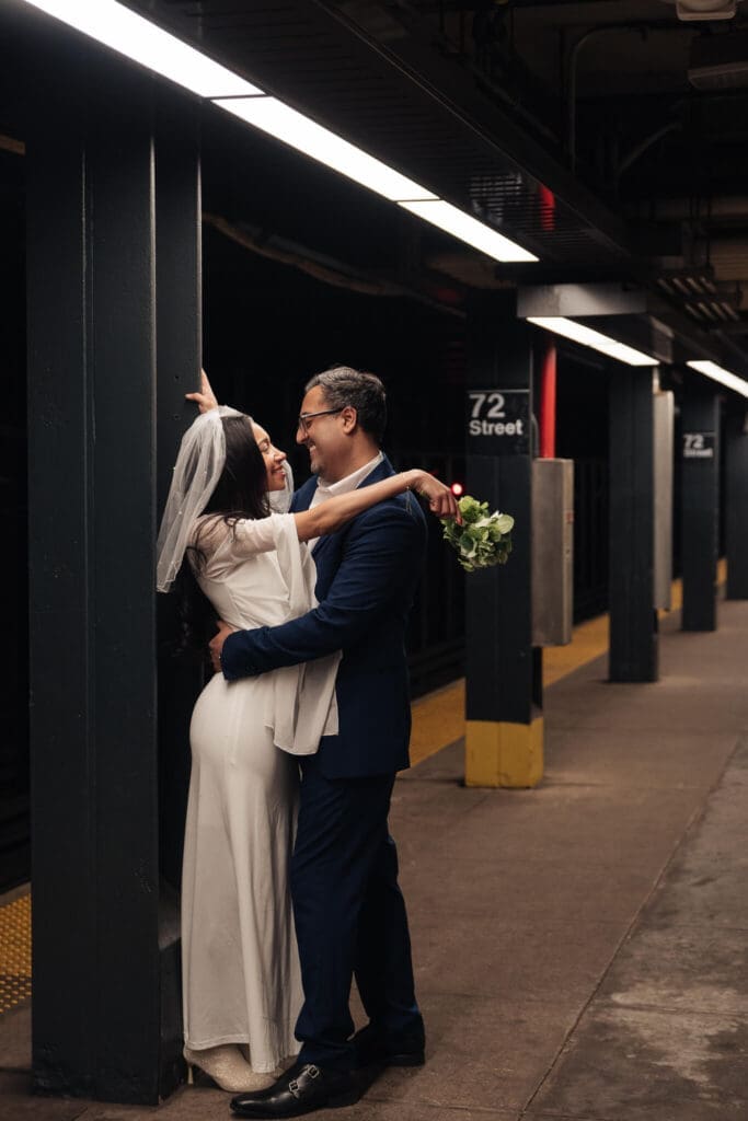 Couple entering subway station after ceremony