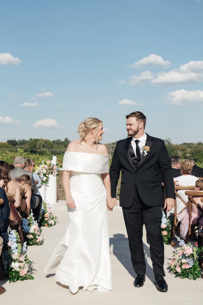 Bridesmaids helping bride into her dress

