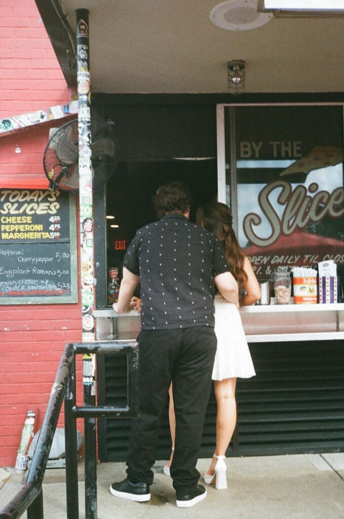 Couple sharing pizza together at Home Slice Pizza in Austin during engagement session