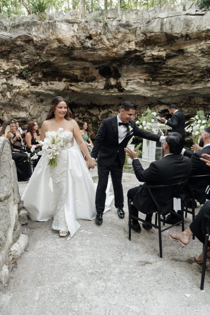 Guests watching emotional cenote wedding ceremony in Cancun