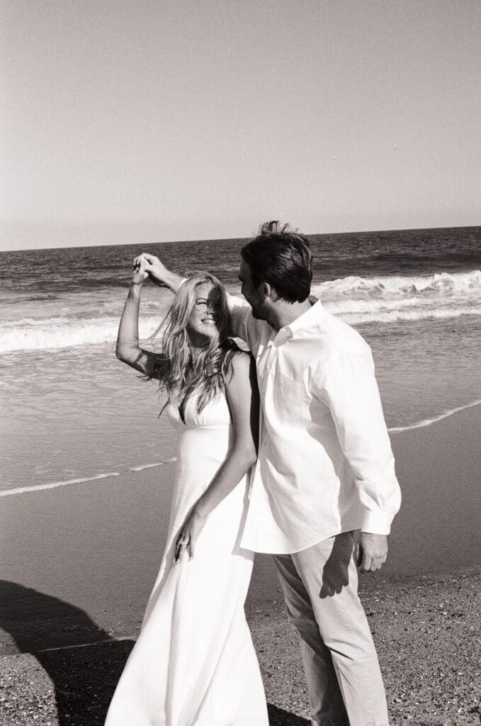 Lewes Delaware engagement photos with romantic shoreline views and soft evening light