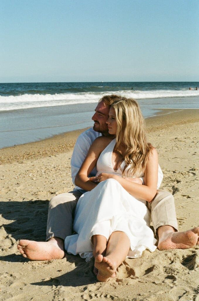 Summer engagement portraits captured at Cape Henlopen State Park during sunset