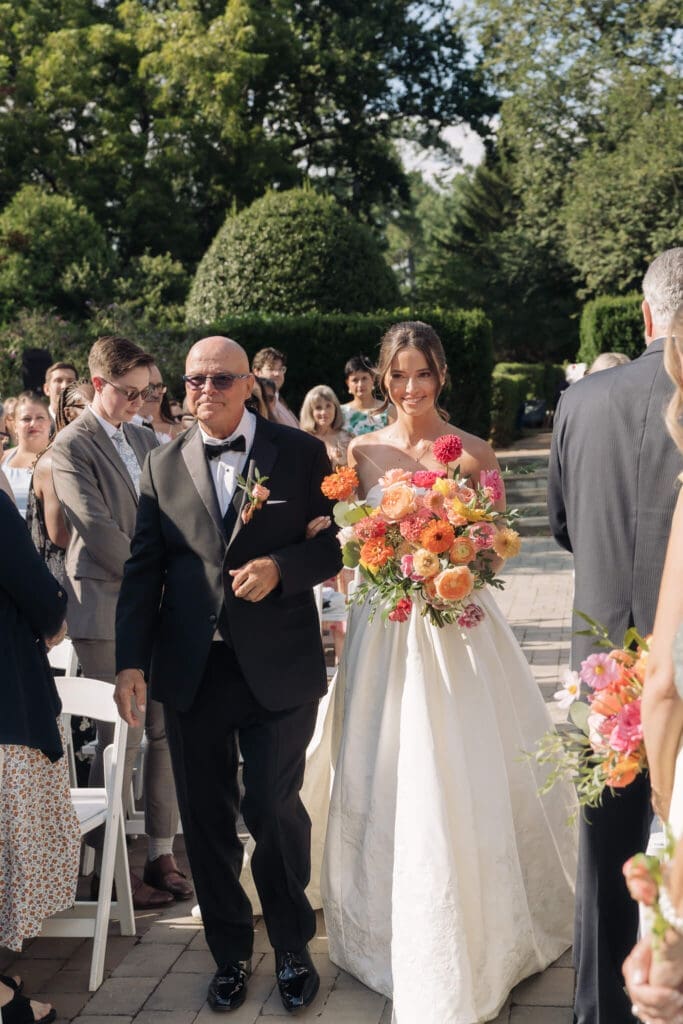 Outdoor Northern Virginia wedding ceremony with vibrant florals