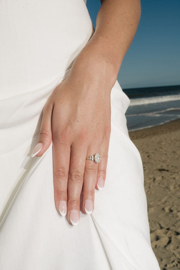 35mm film engagement photo with soft movement and coastal light at Cape Henlopen State Park