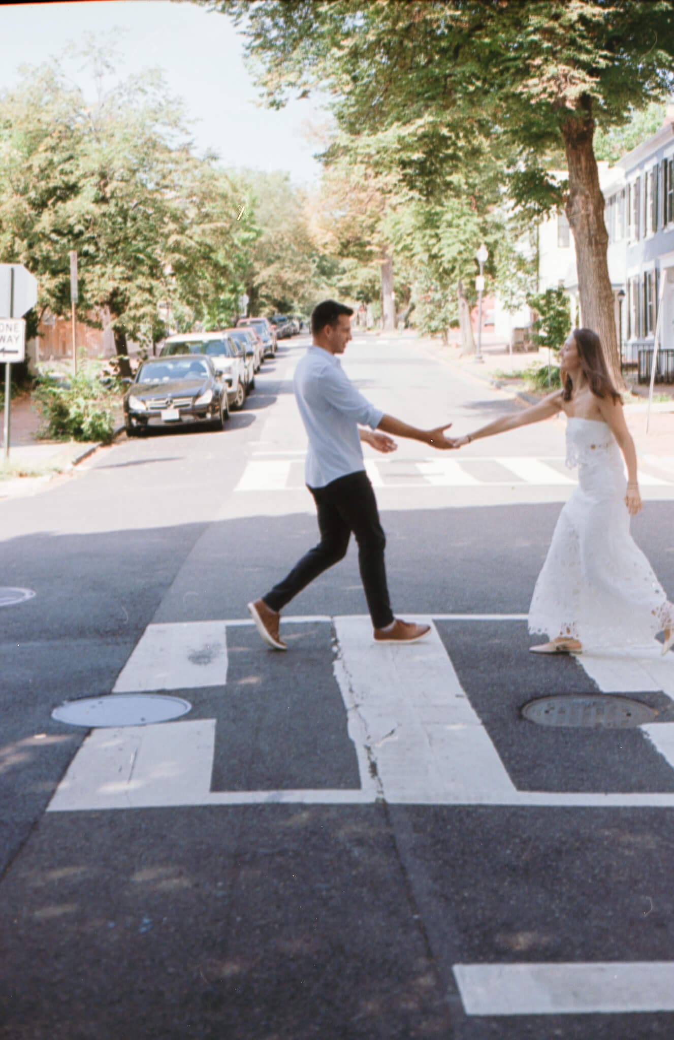 Couple walking through romantic Georgetown sidewalks during engagement session