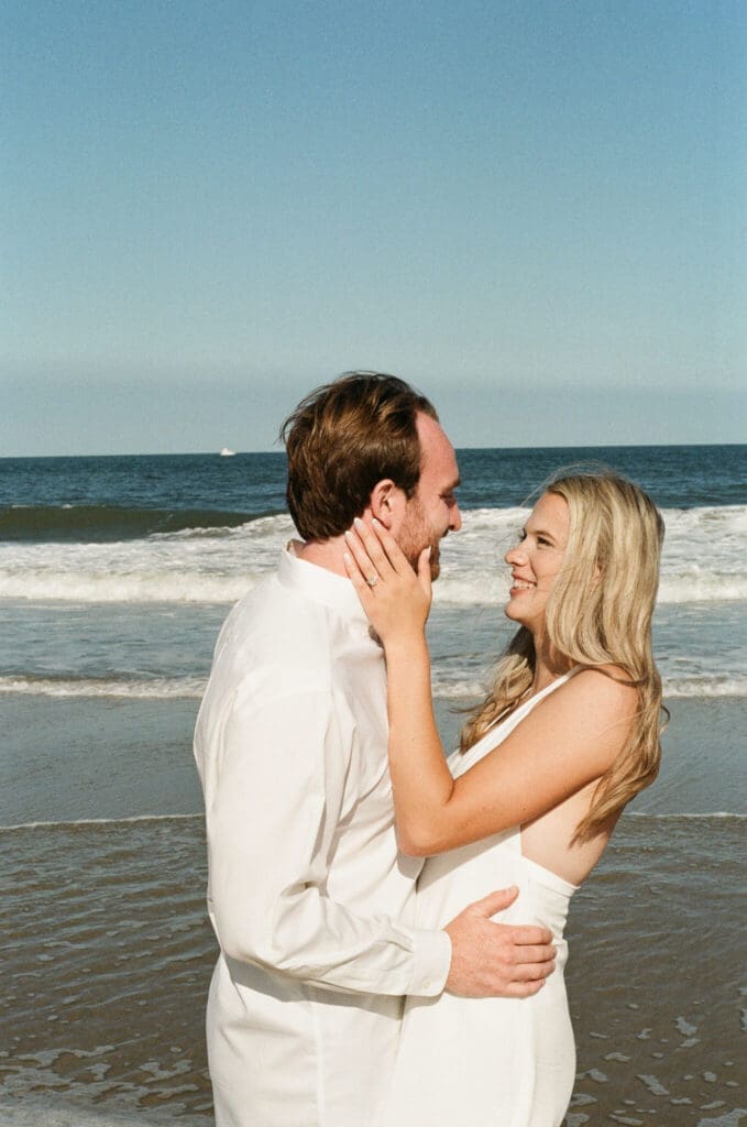 Hybrid film and digital photographer capturing candid moments during a Delaware beach session