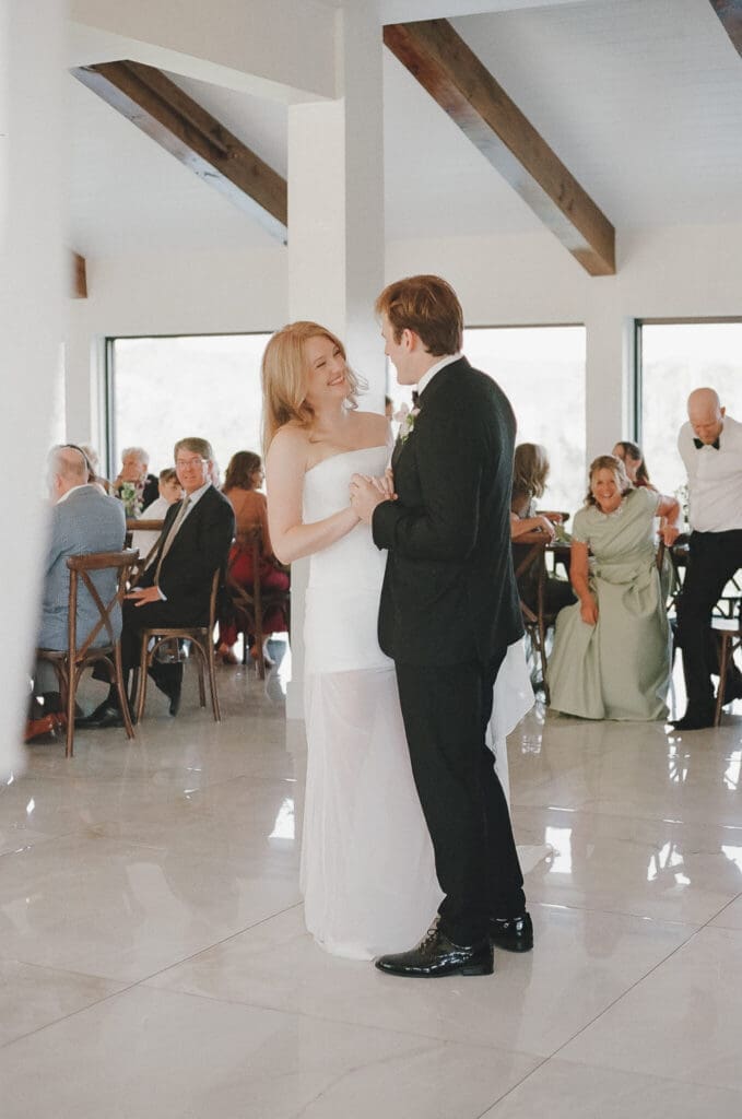 Groom smiling as he sees his bride during the ceremony