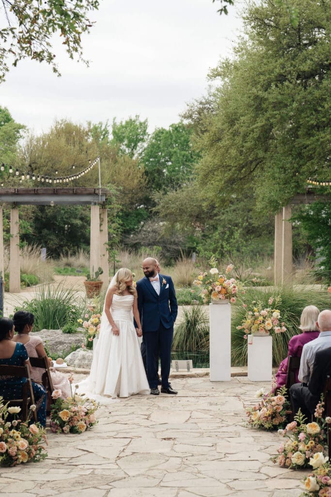 Newly married couple celebrating in the gardens of Lady Bird Wildflower Center