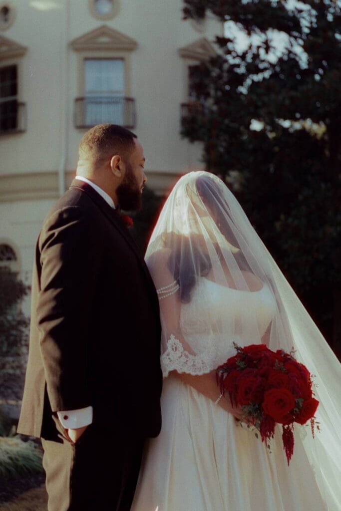 Newlyweds embracing during golden hour portraits photographed with film wedding photography