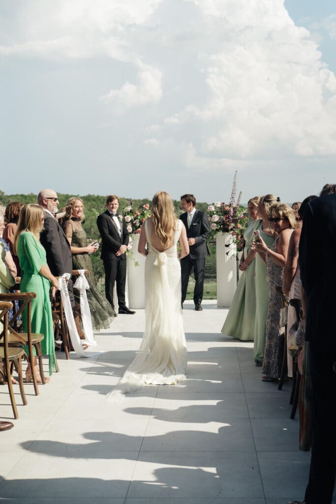 bride walking down the aisle at videre estate wedding in dripping springs texas